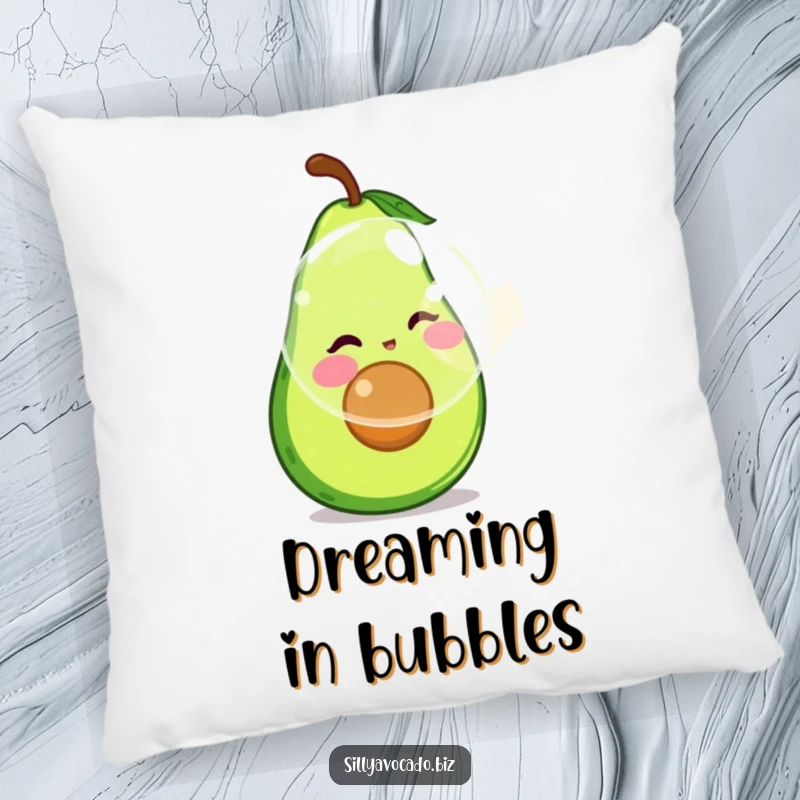 Funny pillow featuring a happy avocado with rosy cheeks focused on blowing a giant, shimmering bubble.