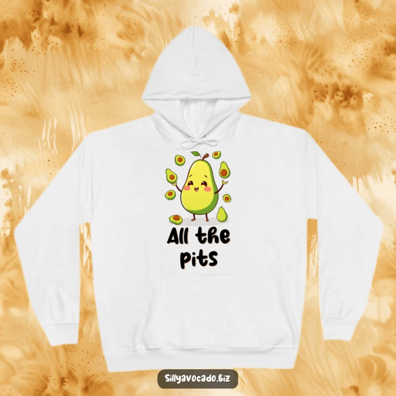 Funny hoodie depicting a smiling avocado on tiny legs, skillfully juggling miniature avocados with a joyful expression.